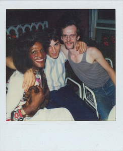 A Photograph Including Marsha P. Johnson and David Combs Sitting Outside on Patio Chairs