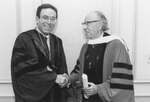Suffolk University President Daniel H. Perlman (1980-1989) and David Reisman at the College of Liberal Arts (CLAS) 50th Anniversary Convocation, photograph, 9/24/1984