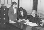 Twins Eleanor Frances and Frances Eleanor O'Brien register for classes at Suffolk University with the help of Registrar Carrolla A. Bryant, photograph, circa 1940