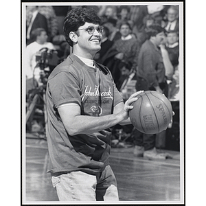 Boston restaurateur Patrick Lyons smiles while preparing to shoot a basketball at a fund-raising event held by the Boys and Girls Clubs of Boston and Boston Celtics