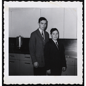 A young man and a boy from the Boys' Clubs of Boston posing in suits