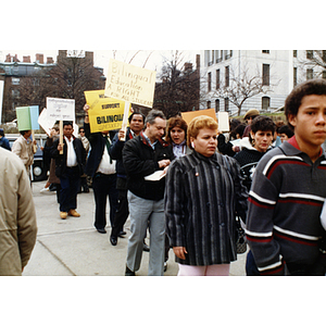 Demonstrators march outside the Massachusetts State House at a rally supporting bilingual education in schools