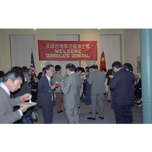 People mingle and eat at a welcome party held for the visiting Consulate General of the People's Republic of China in Boston