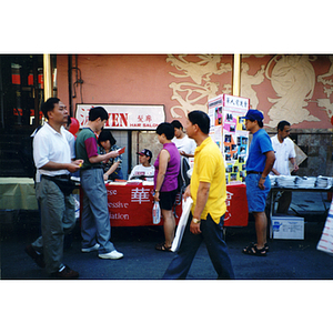 People at the Chinese Progressive Association's table at the August Moon Festival