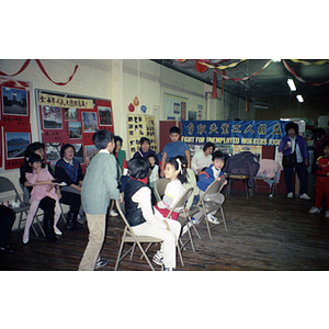 Children play musical chairs at a Chinese Progressive Association event at the Workers' Center