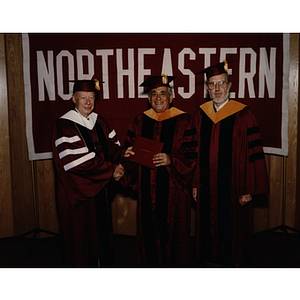 President Kenneth Ryder, left, congratulates George S. Kariotis for his honorary Doctor of Engineering degree