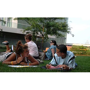 Nadia Alvarez and Odalis Polanco chat while on the grass during a scavenger hunt