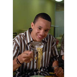 Odalis David Polanco smiles when the Torch Scholars visit the Exhibition Kitchen