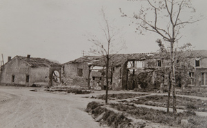 Street-level view of damage to village buildings