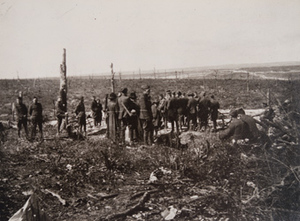 Group of soldiers standing in a war-torn field