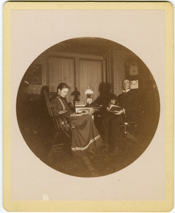 Abby F. Blanchard and C. P. Blanchard, reading at a table in the parlor
