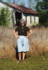 Gloria Xifaras Clark in front of the ruins of the Mt. Zion CME Church, site of the Benton County Freedom School in 1964