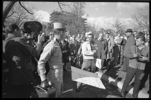 American Nazi Party counter-protester Douglas L. Niles, in uniform, walking past media and onlookers: Washington Vietnam March for Peace