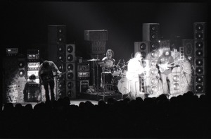 Grateful Dead concert at Springfield Civic Center: band in performance in front of a wall of speakers (spotlight on Bob Weir and Jerry Garcia)