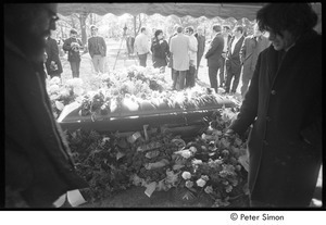 Jack Kerouac's funeral: view of casket at the cemetery, Allen Ginsberg (left) and Gregory Corso (right) in foreground