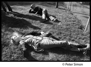 Livingston Taylor, lying on the lawn with a puppy, smoking a cigarette