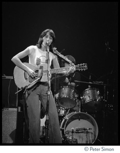 Joan Baez with guitar, performing on stage at the Harvard Square Theater, Cambridge, with the Rolling Thunder Revue