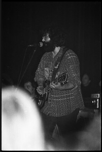 Grateful Dead performing at the Music Hall: Jerry Garcia onstage, playing guitar and singing