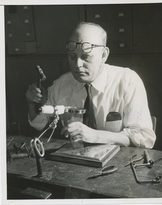 A man engraves the braille portion of the 1955 President's Committee on Employment of the Physically Handicapped Award