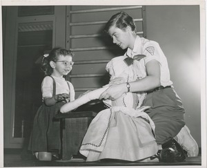 Physical therapist playing with a doll with a child