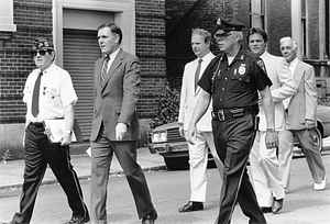 Mayor Raymond L. Flynn marching in the Bunker Hill Day Parade in Charlestown with James Conway, Metropolitan District Commission Officer Bill Connell, State Senator Richard Voke, and City Councilor Robert Travalini