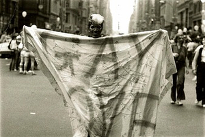 A Photograph of Marsha P. Johnson Holding Up a Blanket That Reads “Gay Love”