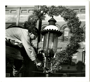 Steven Couto installs Christmas wreath