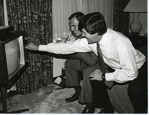 Mayor Raymond L. Flynn seated in front of television with John Kerry