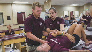 Athletic trainers working in the Athletic Training room