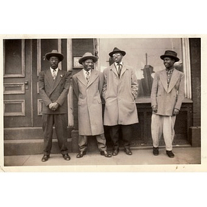 Four unidentified individuals pose in front of a dentist's office on Tremont Street