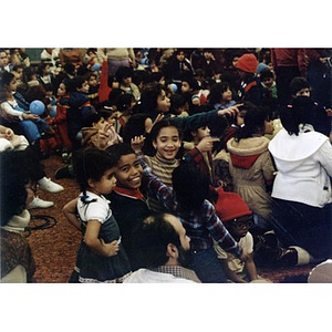Audience, consisting mostly of Hispanic American children and a few adults, watches the Three Kings' Day celebration at La Alianza Hispana, Roxbury, Mass., in 1982