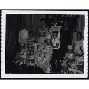 Group portrait of the Little Sister Contest winners with their brothers and three judges, including Richard Harte, Jr., at center