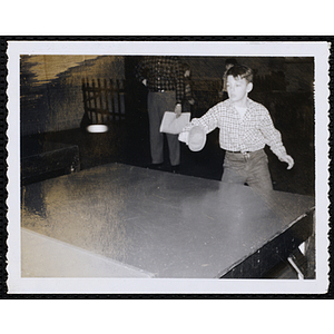 A boy plays table tennis
