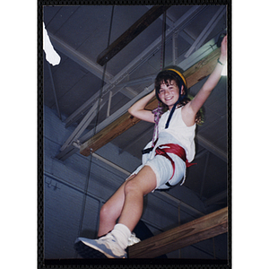 Jennifer Johnson stands on a wood beam in a gymnasium