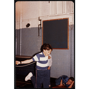 A boy holds a jump rope behind his back at the Charlestown gymnasium