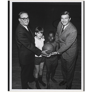 From left to right, Kenneth D. Clapp, Patrick Podolske, Stephen Hendrix, and Frederick J. Davis, holding a basketball together