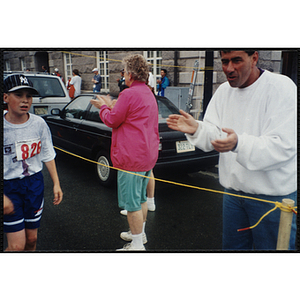 Spectators cheer on a boy running in the Battle of Bunker Hill Road Race