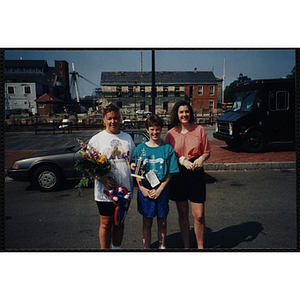 A boy poses with two women during the Battle of Bunker Hill Road Race