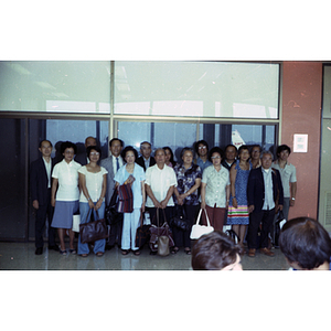 Group poses together at an airport