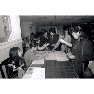 Guests checking in at a Chinese Progressive Association party