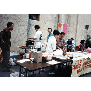 Men and women prepare food at a Chinese Progressive Association event