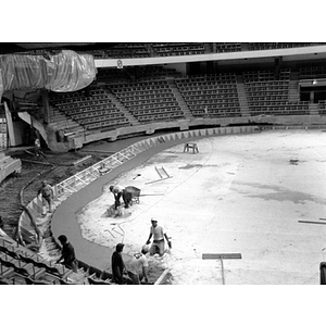 Workmen on the floor of Matthews Arena