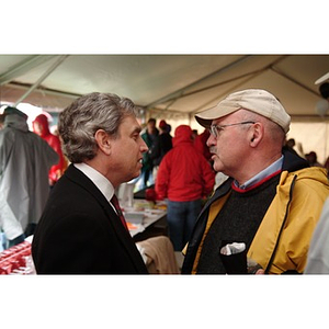 President Freeland speaks with a Northeastern supporter before the Homecoming game