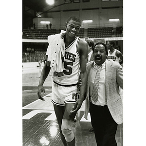 Reggie Lewis and another man celebrating NU victory over BU in basketball