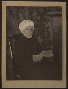 Three-quarter portrait of Mary Perkins Olmsted, seated on a chair, facing front, holding a book, undated