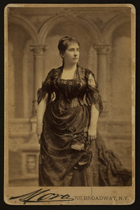 Three-quarter length portrait of Mary Bowen Holt, standing, facing right, Mora, 707 Broadway, New York, New York