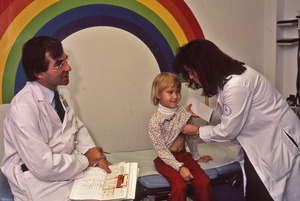 Doctors examining young girl