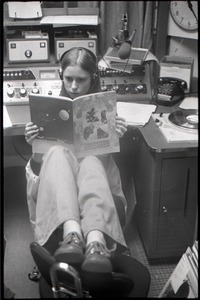 Unidentified woman reading Free Spirit Press magazine in radio studio