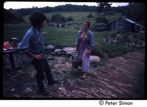 Man and woman with a bucket, Tree Frog Farm Commune