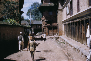 Boy walking down street in Patan